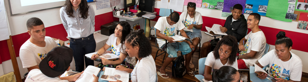 Professora e estudantes em sala de aula.