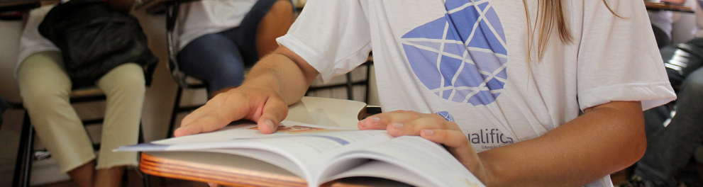 aluno do Qualifica em sala de aula com o livro aberto