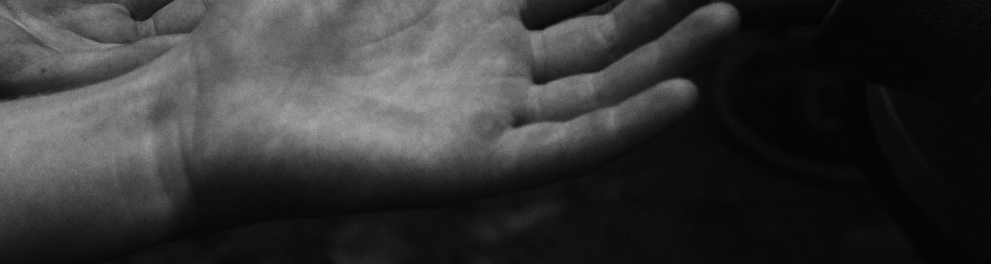Imagem em preto e branco de várias mãos humanos abertas, uma acima da outra