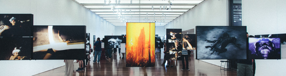 Vários quadros no interior de um museu de arte