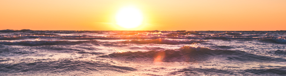 Imagem mostra uma praia enquanto o sol se põe