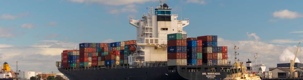 Um navio cargueiro está navegando com uma enorme carga de conteiners