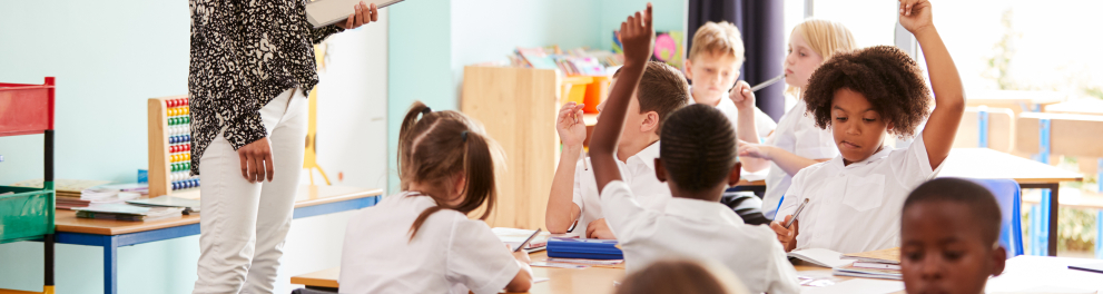 Uma sala de aula com alunos e uma professora