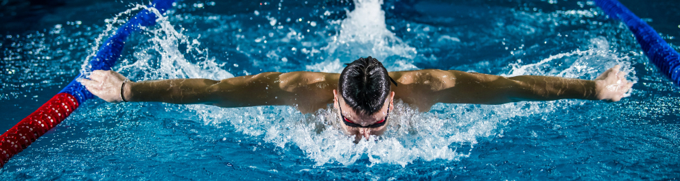 Um homem fazendo natação dentro de uma piscina