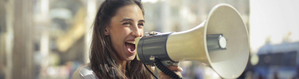 Uma menina usando um megafone na rua